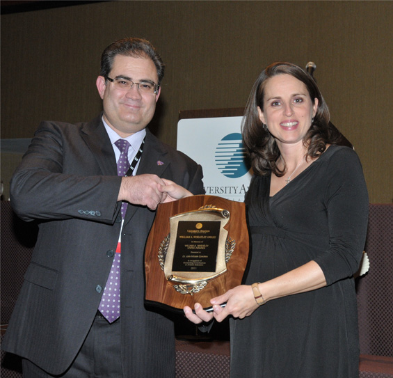 From left, Dr. Kurt Barnhart, president of the University Aviation Association, presents the William A. Wheatley Aviation award to Dr. Julie Speakes, professor and department chair of Commercial Aviation at Delta State University.